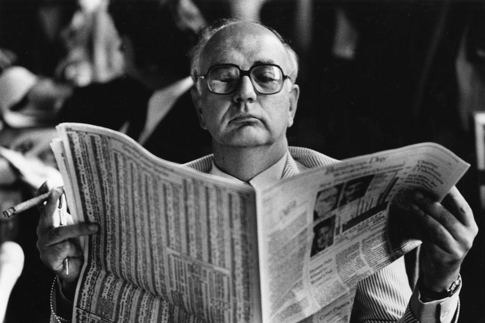 Federal Reserve Chair Paul Volcker reads the financial page as he waits for a hearing in Washington, D.C., on Aug. 5, 1980.