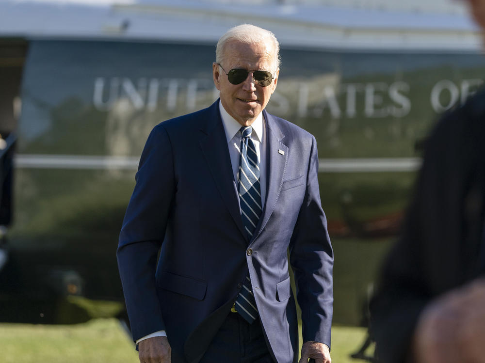 President Biden walks to speak with reporters as he returns to the White House Friday.