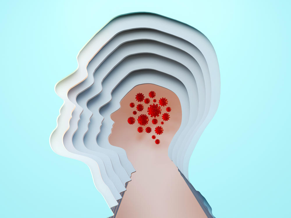 Digital generated image of cut out male head multilayered with covid-19 cells inside on blue background.
