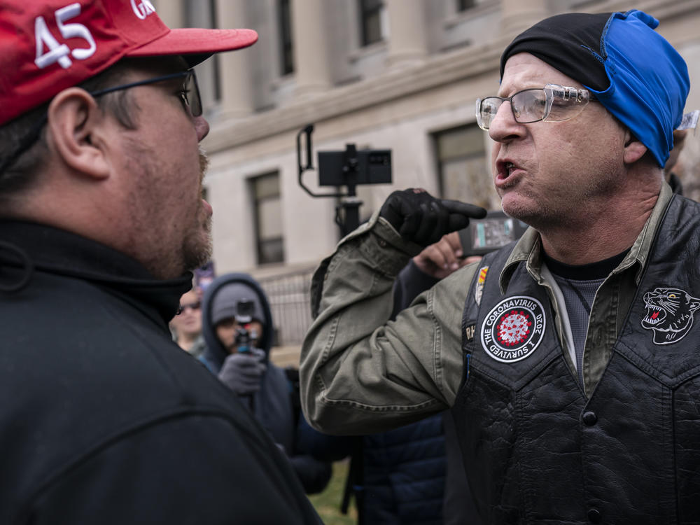 A supporter of Kyle Rittenhouse (left) argues with an activist in favor of conviction (right) in front of the Kenosha County Courthouse while the jury deliberates the Rittenhouse trial on Wednesday in Kenosha, Wisc.