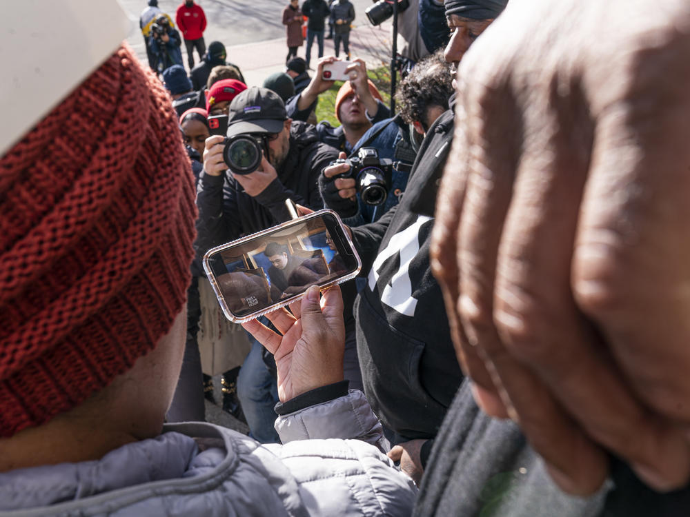 Bystanders on the steps of the courthouse watch as the verdict is read in the trial of Kyle Rittenhouse. Legal experts said Rittenhouse's claim of self-defense was strong from the beginning.