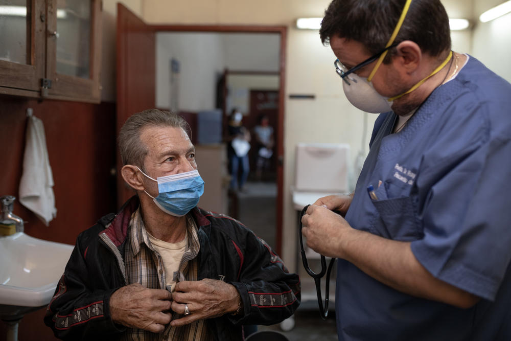 Raymond Portelli, priest and doctor, treats a patient in his clinic inside the San Martin de Porres church in Iquitos, Peru.