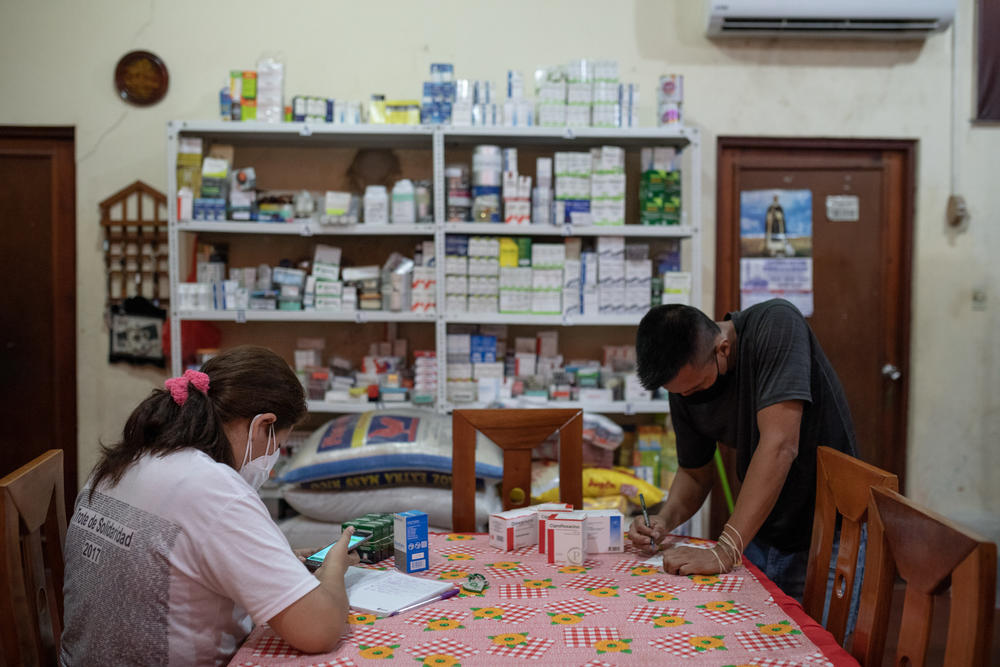 Volunteers sort medicines that are distributed free of charge at a medical clinic in the San Martin de Porres church in Iquitos, Peru. The pastor of the church was instrumental in bringing in a desperately-needed oxygen plant to the city in the worst days of the COVID pandemic.
