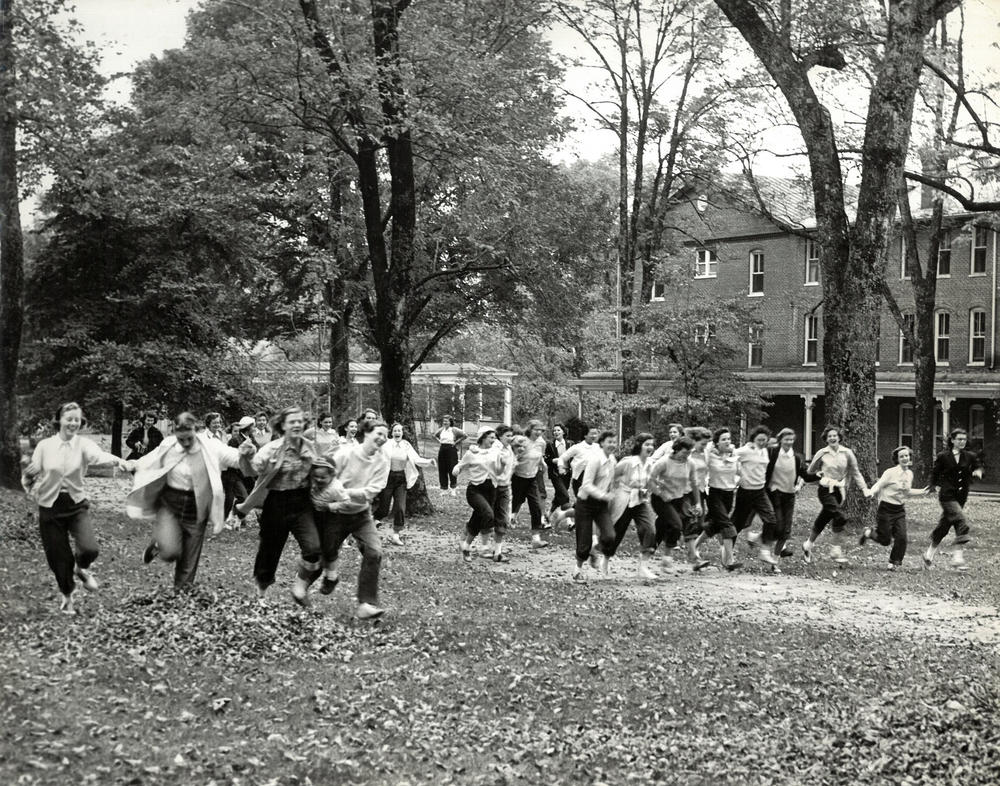 Hollins students run across campus on Tinker Day, 1950. One of the school's oldest traditions, the celebration is held on a surprise day each fall.