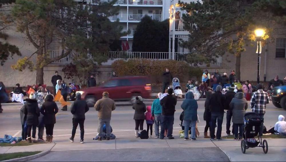 A red vehicle is seen speeding through a parade route in Waukesha, Wis., in a livestreamed video on the city of Waukesha's Facebook page.
