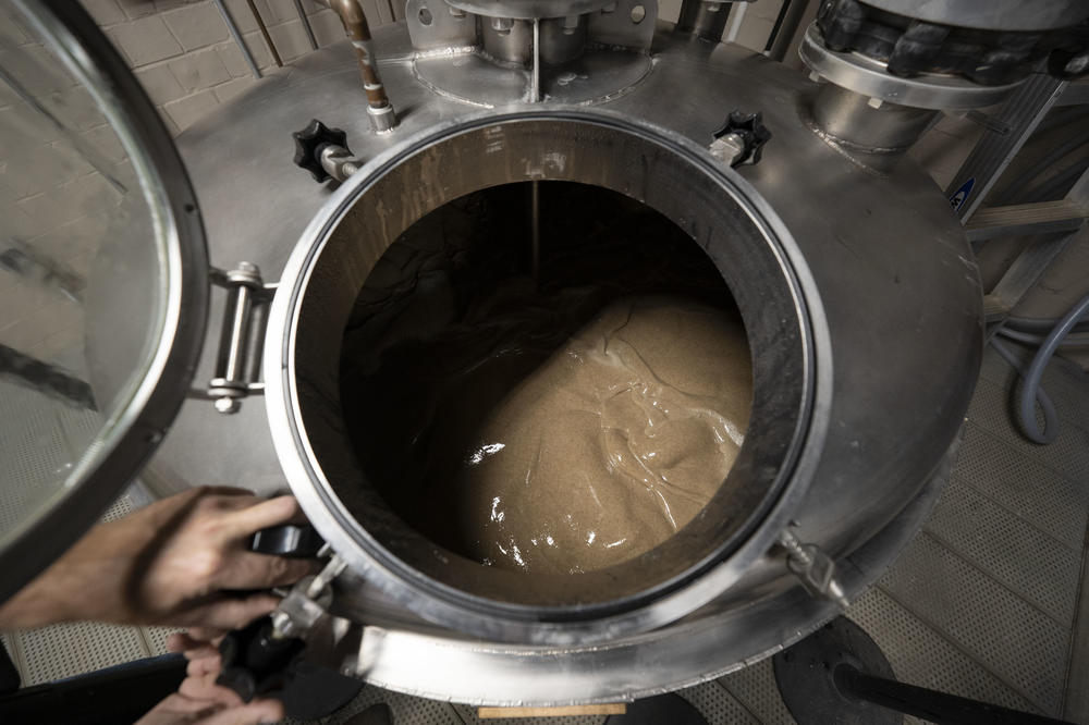 Master distiller Aaron Schorsch inspects the mash.