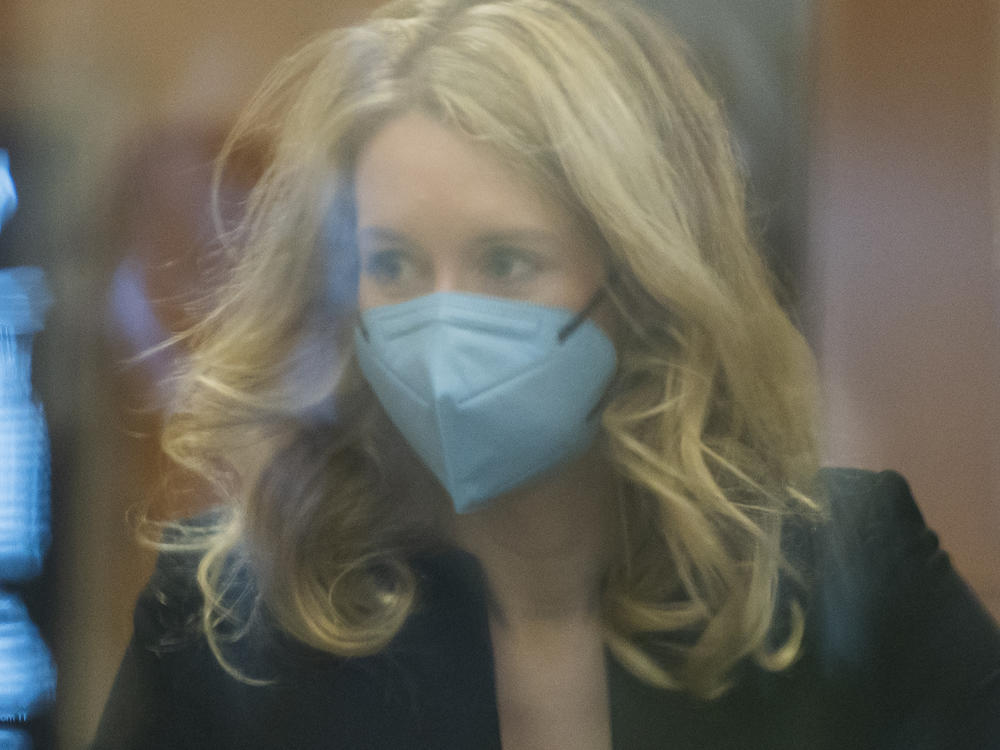 Elizabeth Holmes walks into federal court in San Jose, Calif., on Monday. Holmes is accused of duping elite financial backers, customers and patients into believing that her startup was about to revolutionize medicine.