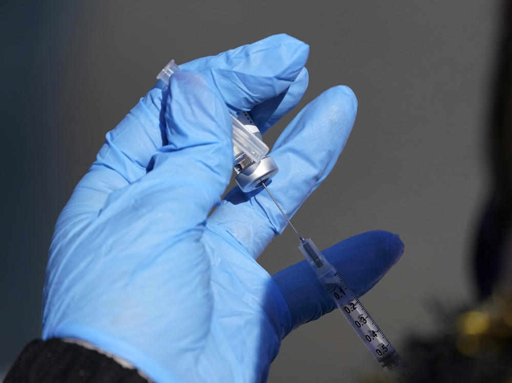 A nurse fills a syringe with COVID-19 vaccine at a mass vaccination site in Kansas City, Mo. on March 19, 2021.