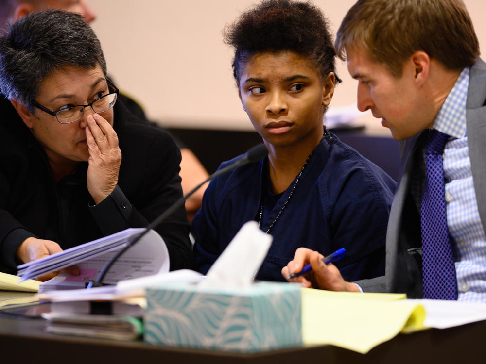 Chrystul Kizer (shown here with her lawyers in 2019) is arguing that it was self-defense when she killed the man who sexually abused her.