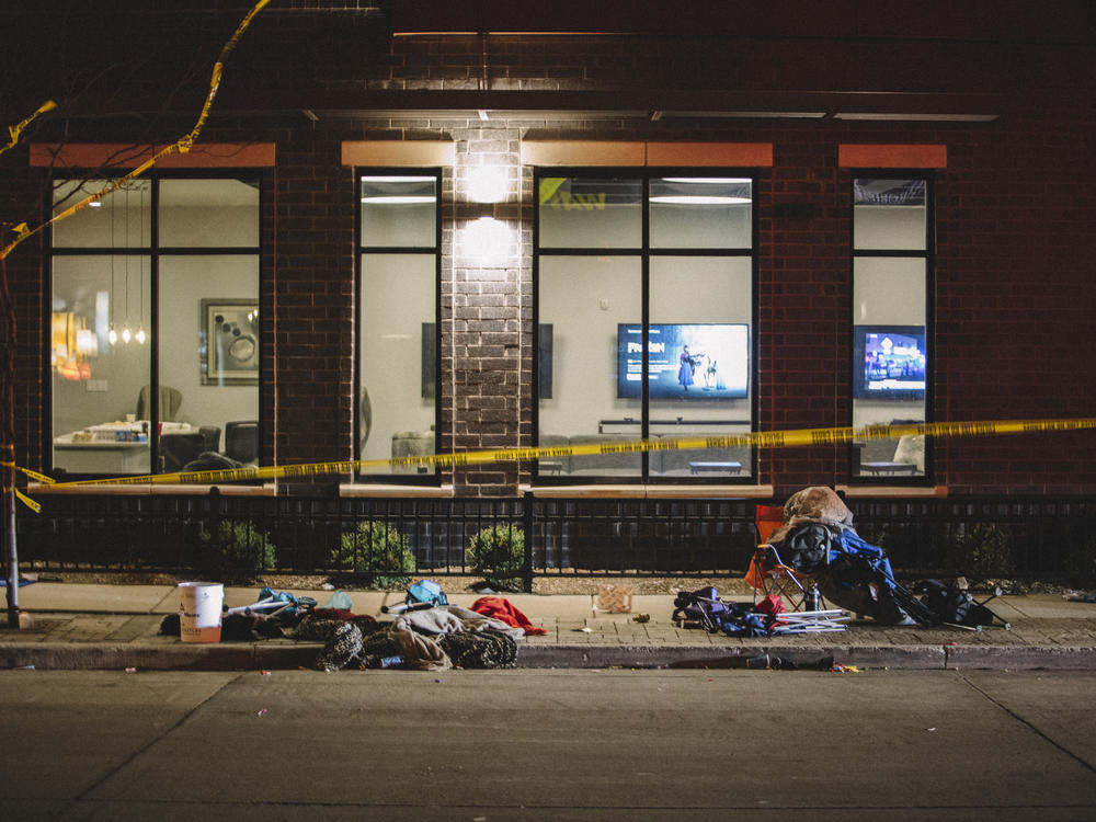 Debris litters the street at a crime scene on Sunday in Waukesha, Wis., after a person in an SUV slammed into pedestrians at a Christmas parade.