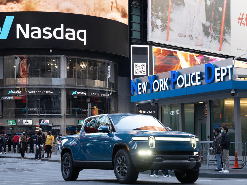 A Rivian R1T electric pickup truck is displayed outside the Nasdaq MarketSite in Times Square, New York, on Nov. 10. Shares in the electric truck maker gained strongly in their first day of trading after completing its IPO.