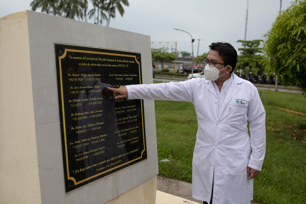 Juan Carlos Celis Salinas, a doctor at the Loreto Regional Hospital, stands by a memorial to the medical staff who died from COVID-19 during the first wave in Iquitos, Peru.
