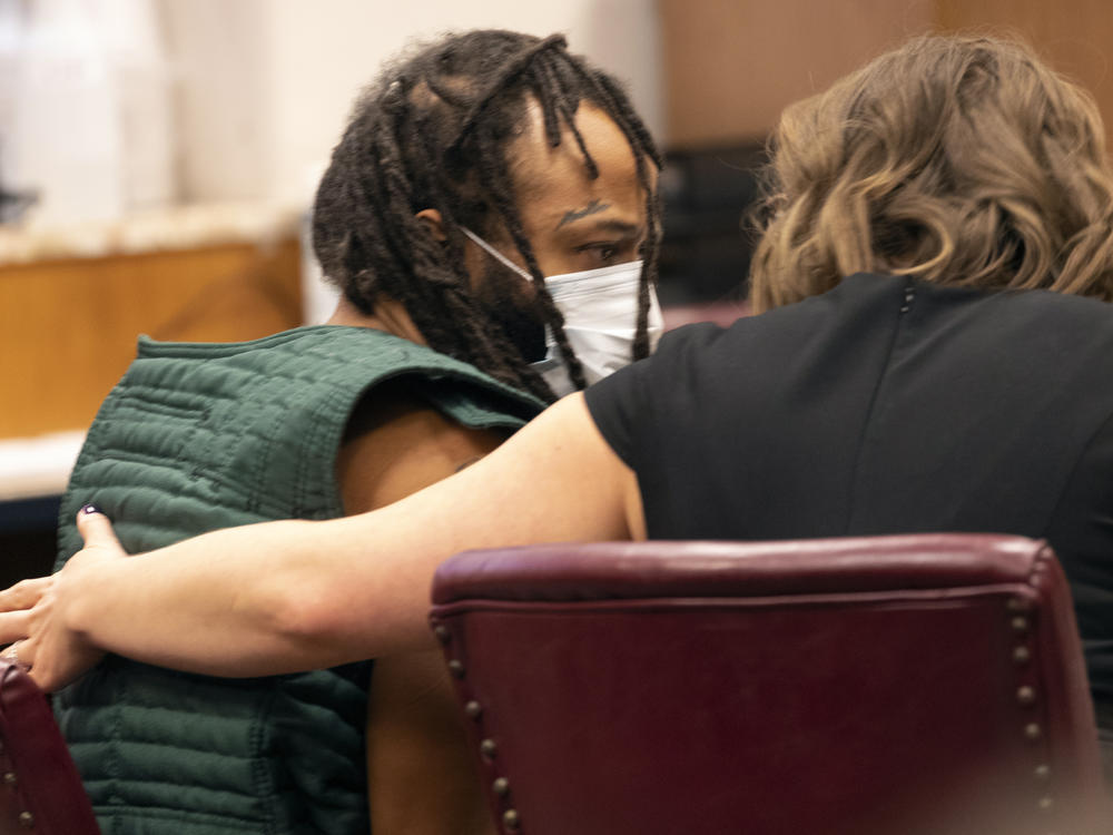 Darrell Brooks, left, speaks with a lawyer during his initial appearance, Tuesday, Nov. 23, 2021 in Waukesha County Court in Waukesha, Wis. Brooks is charged with intentional homicide after SUV was driven into a Christmas parade.