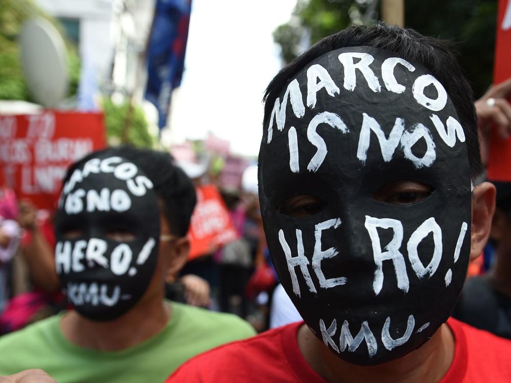 Activists wear masks with anti-Marcos slogans during a rally in front of the Supreme court in Manila in 2016 as they await the high court's decision on whether to allow the burial of the late Philippine dictator Ferdinand Marcos at the 