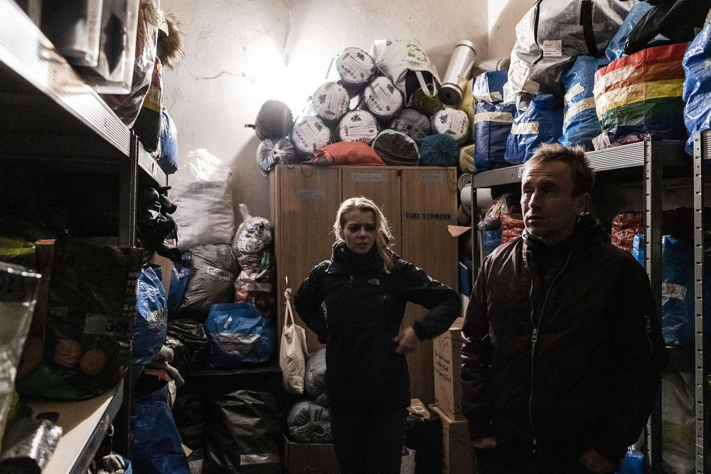 Employees and volunteers from Ocalenie Foundation, one of the main organizations helping at the border, look at their supplies during a briefing between shifts in their temporary office in Sokolka.