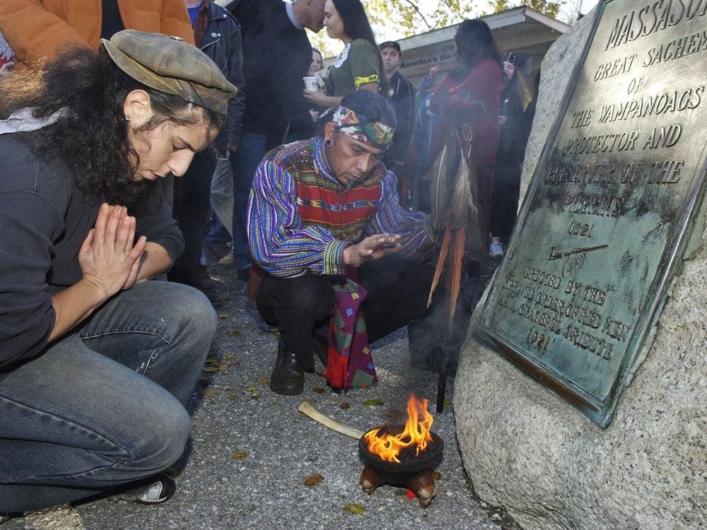 Supporters of Native Americans pause following a prayer during the 38th National Day of Mourning at Coles Hill in Plymouth, Mass., on Nov. 22, 2007. Denouncing centuries of racism and mistreatment of Indigenous people, members of Native American tribes from around New England will gather on Thanksgiving 2021 for a solemn National Day of Mourning observance.