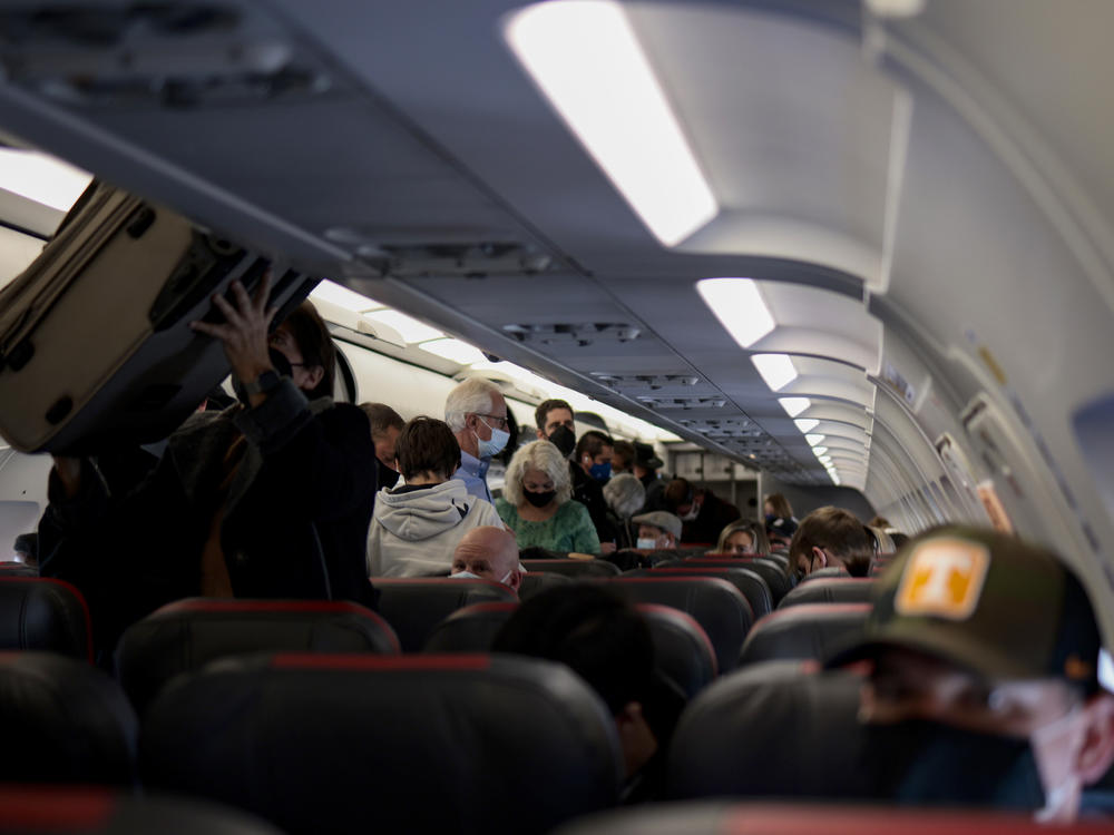 Passengers deplane from an airplane after landing at the Albuquerque International Sunport on Nov. 24, 2021 in Albuquerque, New Mexico.