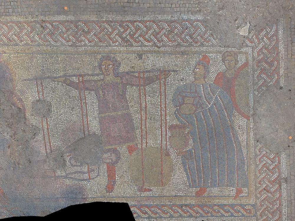 A panel of the mosaic discovered by a team of archaeologists in England. The researchers say it shows the body of Hector returning to his father, King Priam (right), in exchange for his weight in gold.