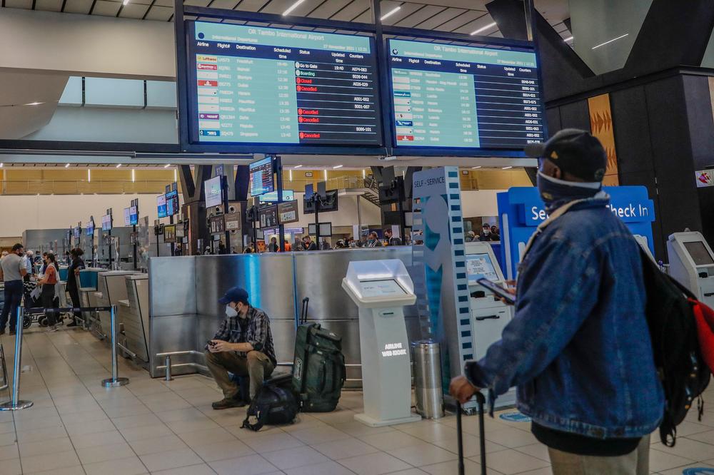A passenger checks an electronic flight notice board displaying canceled flights at OR Tambo International Airport in Johannesburg, South Africa.
