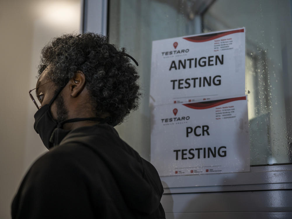 A person waits to be tested for COVID-19 in Johannesburg, South Africa, on Saturday. The omicron variant, first identified in South Africa, has been confirmed in several countries.