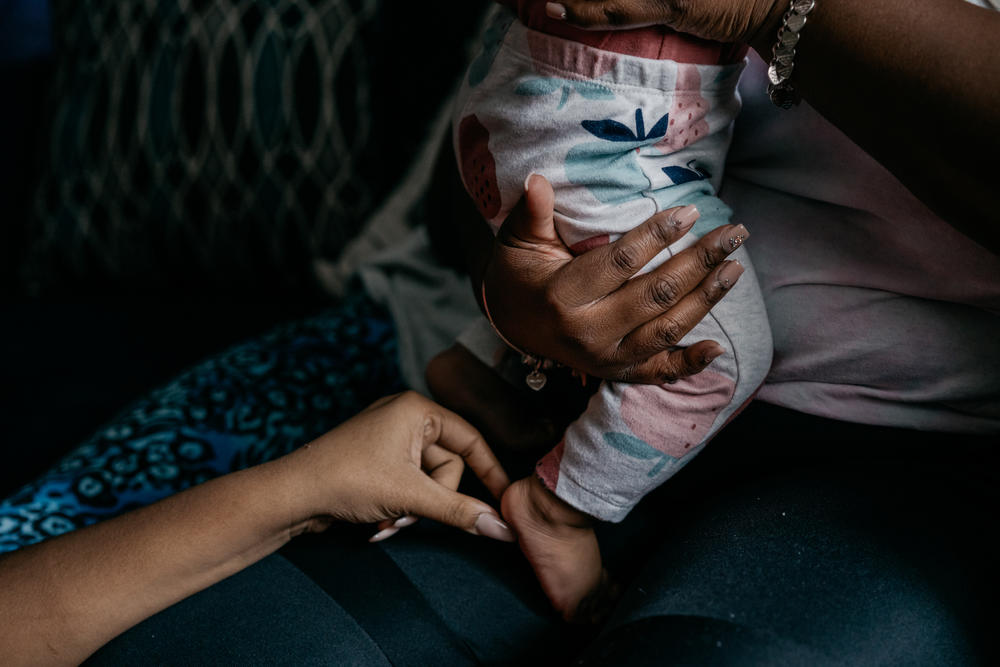 Cassie Washington holds her youngest daughter, Cali, who is 8 months old. Washington has been in a healthy two-year relationship with her partner.