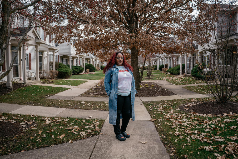 Cassie by her home in Aurora, Illinois. Before moving to a subdivision she would take her daughters to trick or treat there, she dreamed of one day living in a neighborhood like it.