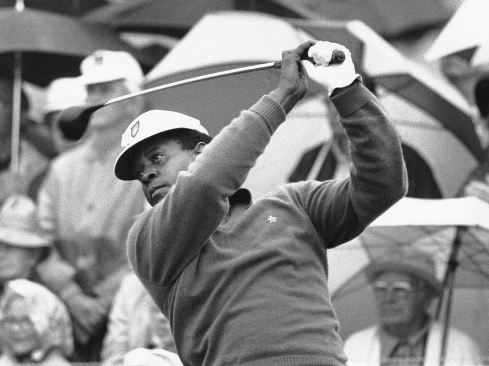 Lee Elder watches the flight of his ball as he tees off in the first round of play at the Masters in Augusta, Ga., on April 10, 1975. Elder broke racial barriers as the first Black golfer to play in the Masters and paved the way for Tiger Woods and others to follow.
