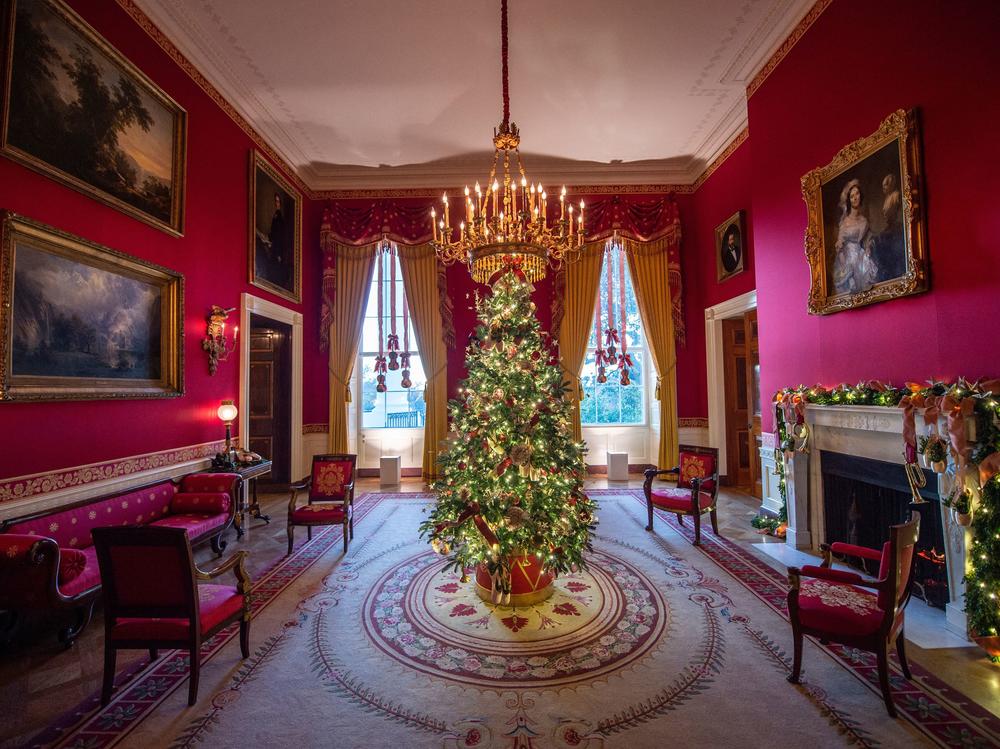 A Christmas tree stands in the Red Room during a press preview of White House holiday decorations on Nov. 29.
