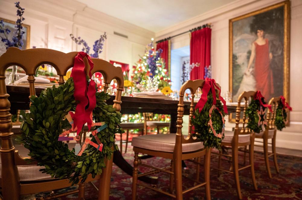 Wreathes decorate the backs of chairs in the room that displays the White House's collection of state china. The holiday decorations symbolize the gift of friendship and sharing.