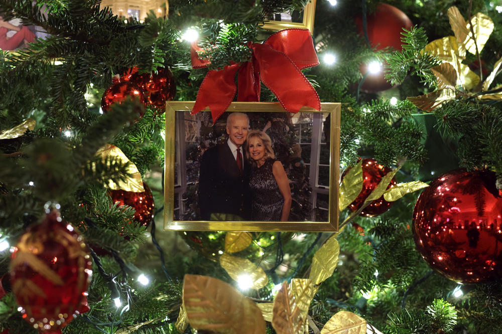 An ornament with a portrait of President Biden and first lady Jill Biden hangs on a Christmas tree in the State Dining Room of the White House during a press preview of holiday decorations on Nov. 29.