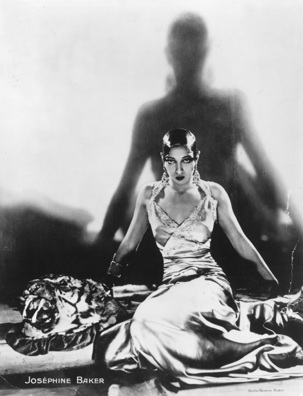 Singer and dancer Josephine Baker, sitting on a tiger rug, circa 1925.