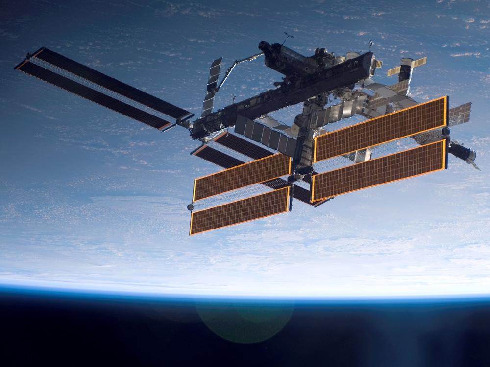 International Space Station is seen over a blue and white Earth, taken shortly after the Space Shuttle Atlantis undocked from the orbital outpost.
