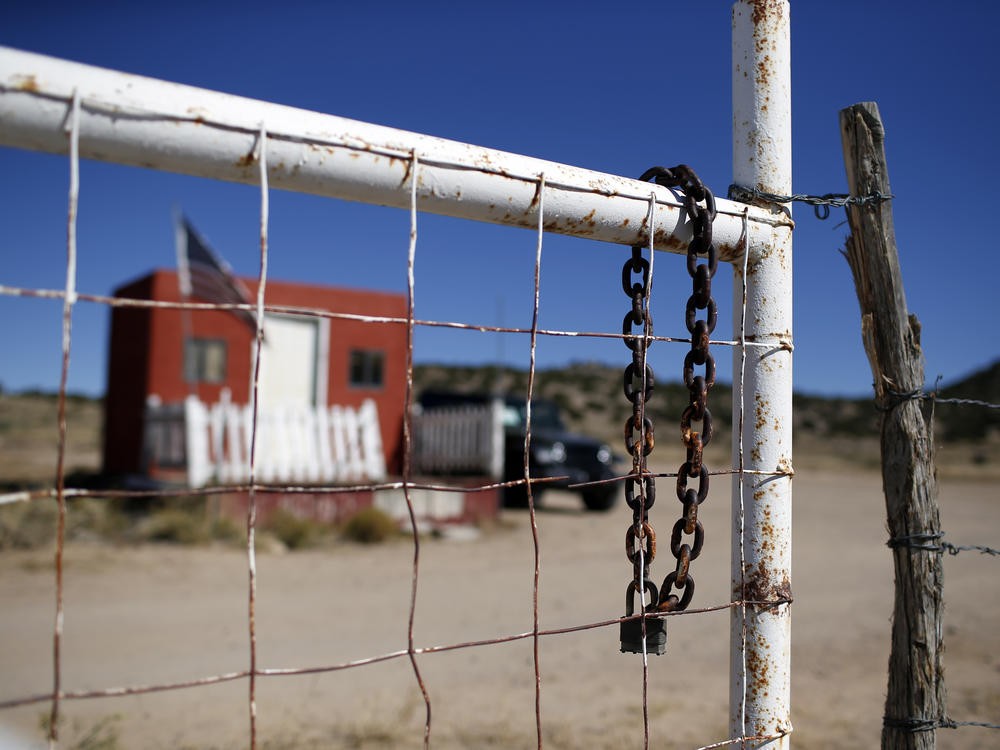 A rusted chain hangs on the fence at the entrance to the Bonanza Creek Ranch film set in Santa Fe, N.M., on Oct. 27.