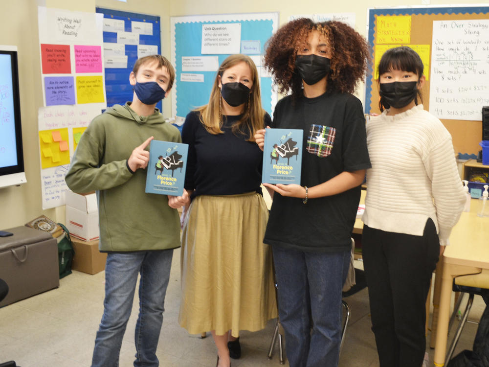 Three of the student authors of <em>Who Is Florence Price? </em>(left to right: Sebastián Núñez, Hazel Peebles and Sophia Shao), joined by their English teacher, Shannon Potts.
