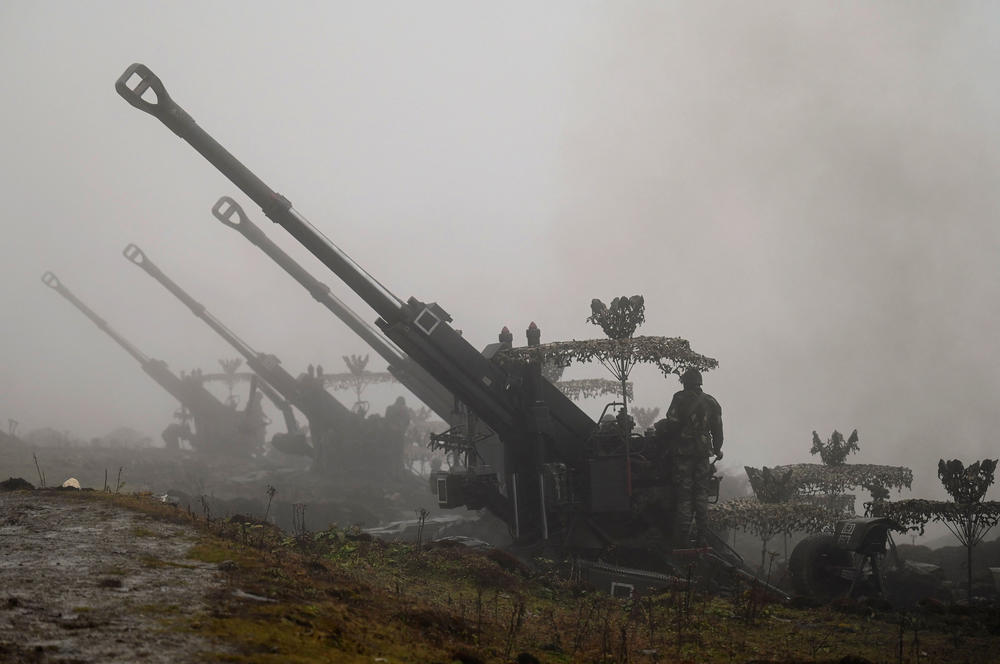 Indian Army soldiers stand next to Bofors guns positioned at Penga Teng Tso ahead of Tawang, near China's border in India's Arunachal Pradesh state on Oct. 20.