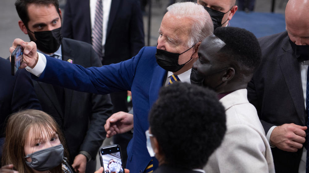 President Biden takes a selfie with a supporter after speaking at the Dakota County Technical College in Rosemount, Minn., on Tuesday.