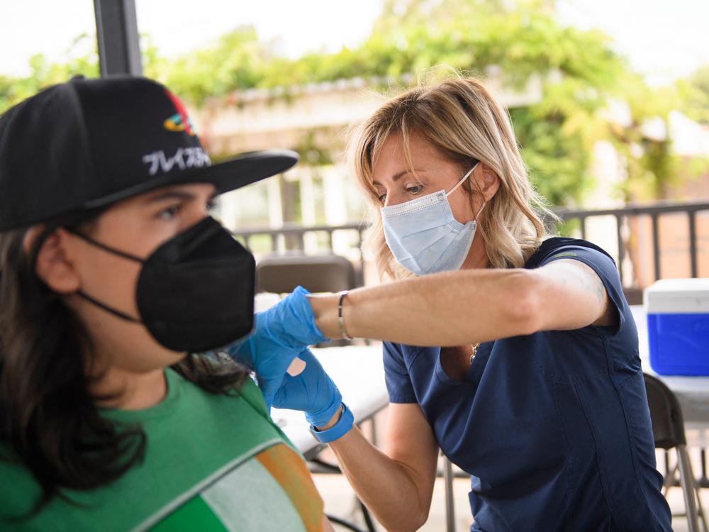 A nurse administers a dose of the Pfizer COVID-19 vaccine during a City of Long Beach Public Health mobile vaccination clinic at the California State University, Long Beach campus.