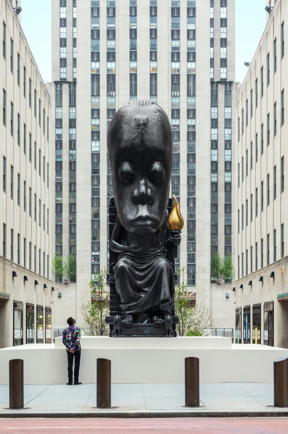 Sanford Biggers looks up at his <em>Oracle</em> sculpture when it was on display at the Rockefeller Center last spring.
