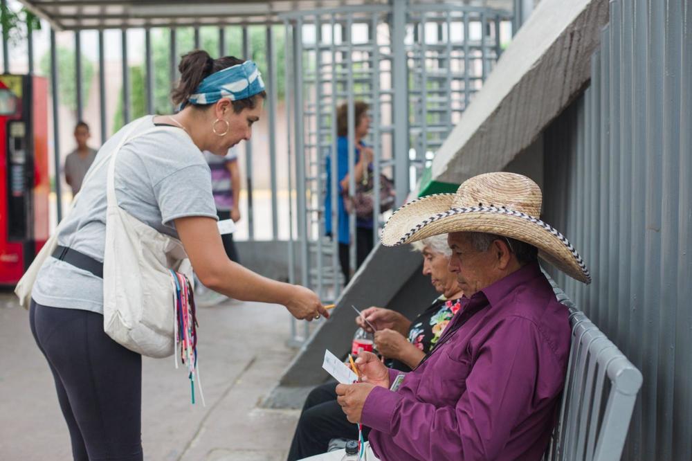 Artist Tanya Aguiñiga asking people who cross the U.S.-Mexico border communities to participate in the making of her art project <em>Border Quipu</em>.
