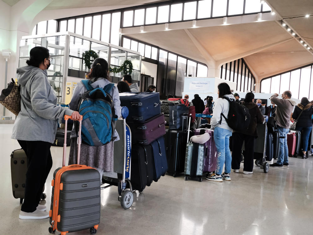 Travelers arrive for flights at Newark Liberty International Airport in New Jersey on Nov. 30.