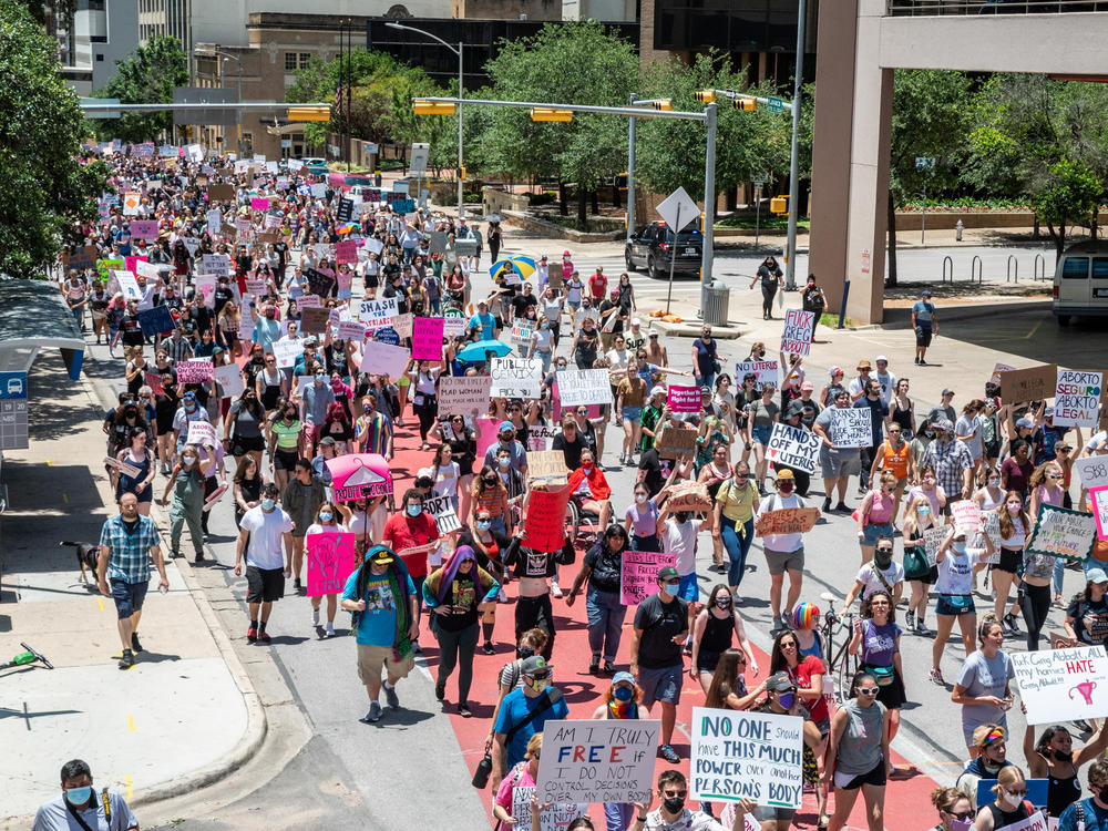 Protesters march down Lavaca Street at a protest outside the Texas state capitol on May 29, 2021 in Austin, Texas. Thousands of protesters came out in response to a new bill outlawing abortions after a fetal heartbeat is detected signed on Wednesday by Texas Governor Greg Abbot.