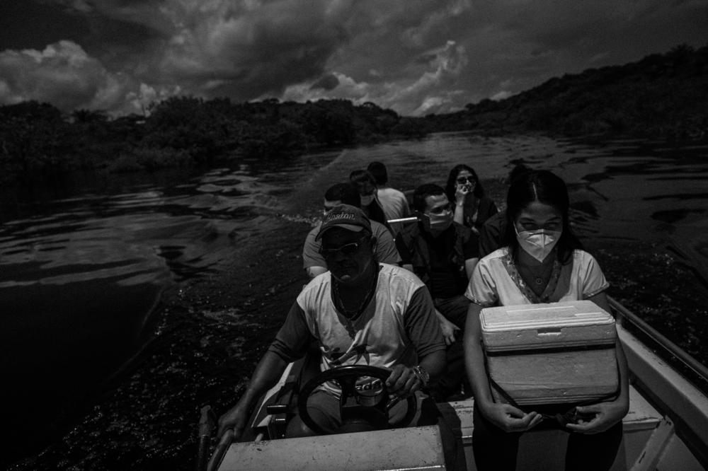 A health team from the municipality of Iranduba, Amazonas, Brazil, navigates the waters of the Rio Negro, taking doses of the COVID-19 vaccine to riverside communities in the region, on April 15, 2021. Iranduba was one of the municipalities that suffered the most from the pandemic in Amazonas.