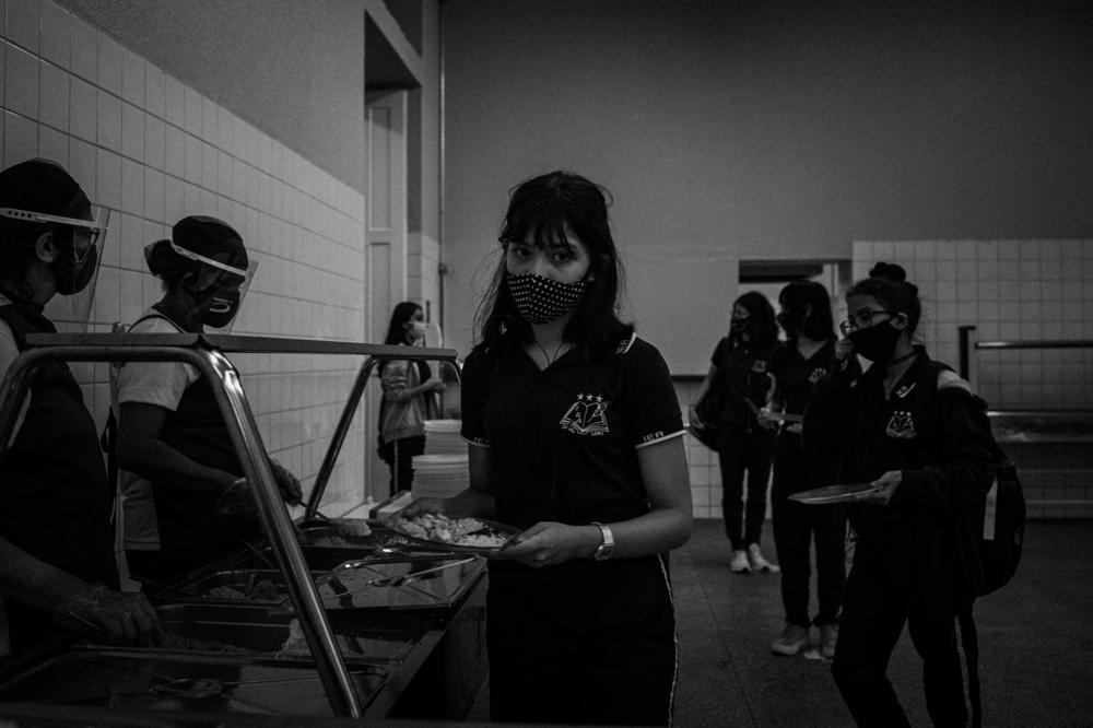 A student has her lunch served at the Instituto de Educação public school in Manaus, on Aug. 13, 2020. Manaus was still experiencing the first wave of the disease when about 110,000 students returned to school.