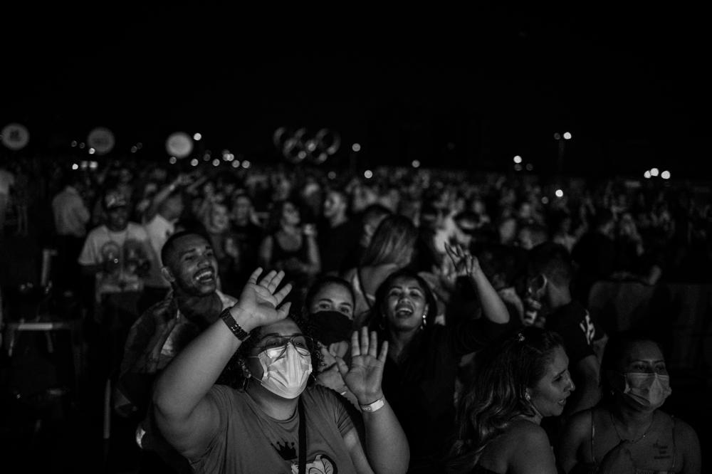 A city punished by COVID-19, Manaus, capital of Brazil's Amazonas state, hosts a trial run for public events during the pandemic, on Sept. 25, 2021. More than 2,000 people attended the musical show, but very few wore face masks.