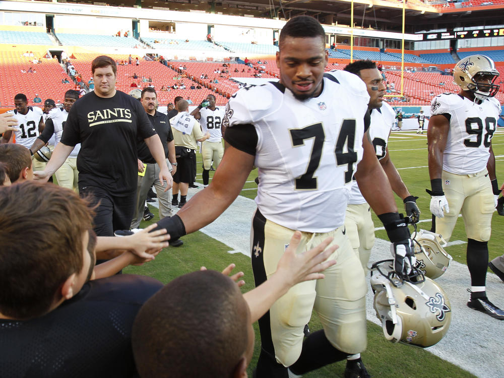 New Orleans Saints defensive end Glenn Foster Jr. greets fans before an NFL preseason game against Thursday, Aug. 29, 2013 in Miami Gardens, Fla. Foster died on Monday while in police custody.