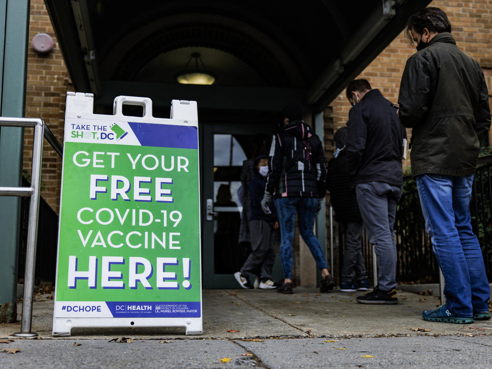 People line up outside of a free COVID-19 vaccination site that opened in Washington, DC in December.