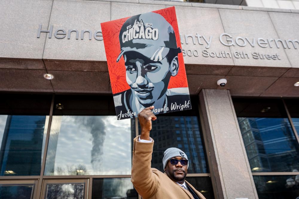 Philonise Floyd, George Floyd's brother, holds a portrait of Daunte Wright outside the Hennepin County Government Center in Minnesota as Kim Potter's trial began Wednesday.