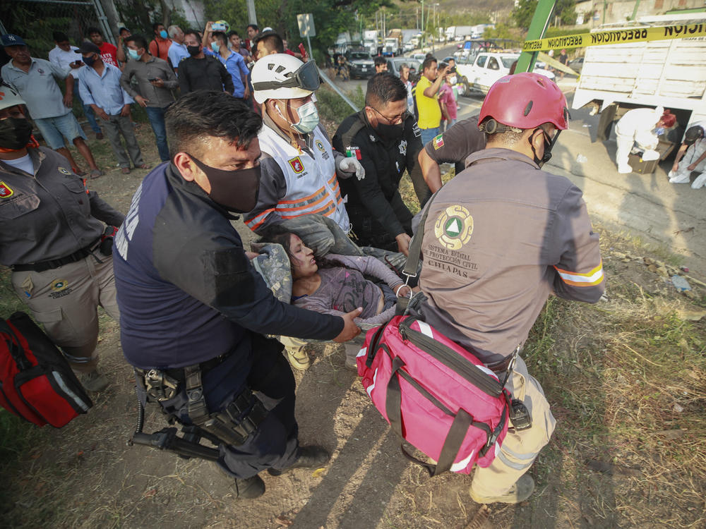An injured migrant woman is moved by rescue personnel from the site of an accident near Tuxtla Gutierrez, Chiapas state, Mexico, on Thursday.