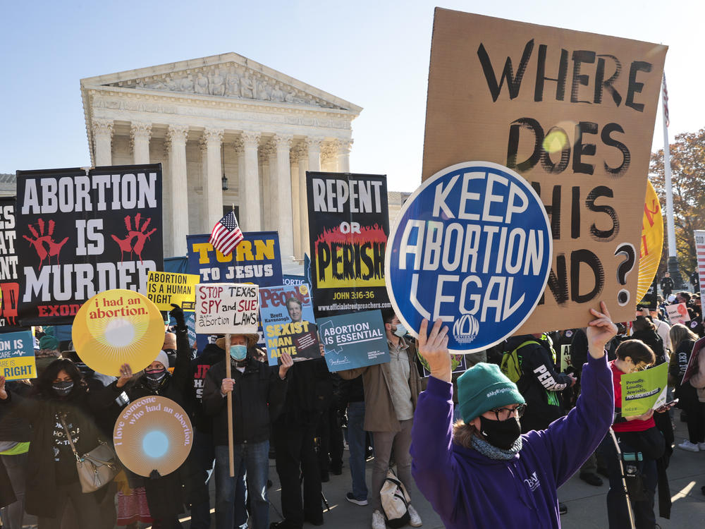 Demonstrators gather in front of the Supreme Court as the justices hear arguments earlier this month in <em>Dobbs v. Jackson Women's Health</em>, a case about a Mississippi law that bans most abortions after 15 weeks.