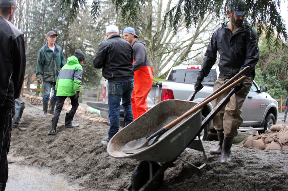 Volunteers and residents create flood barriers in a low-lying neighborhood of Abbotsford, British Columbia, on Nov. 28.